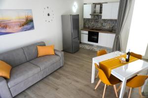 a living room with a couch and a table at L'Angolo di Mimma in Porto Cesareo