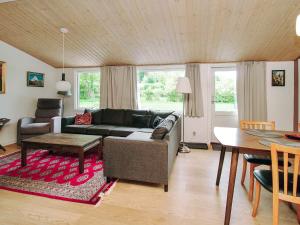 a living room with a couch and a table at 8 person holiday home in Holbæk in Holbæk +31 photos