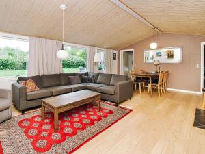 a living room with a couch and a table at 8 person holiday home in Holbæk in Holbæk