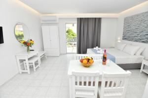 a living room with a couch and a table with a bowl of fruit at Casa al'tati studios in Ialyssos +11 photos