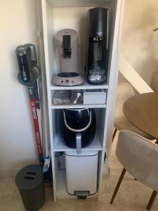 a shelf with a coffee maker and a coffeemaker at Les Jardins du Soleil in Vic-la-Gardiole +18 photos