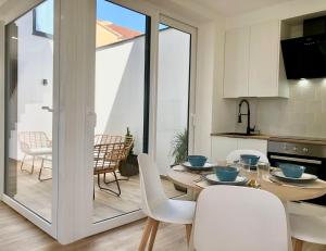 a kitchen and dining room with a table and chairs at A caseta de Sil in Lira