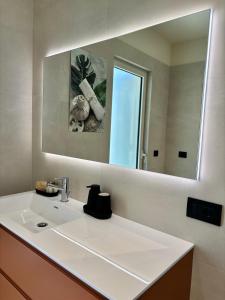a bathroom with a white sink and a mirror at Settanni Suites in Polignano a Mare +75 photos