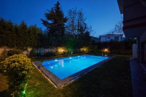 a swimming pool in a yard at night at Andalus Villas NO ALCOHOL ALLOWED with Heated Pool in Sapanca