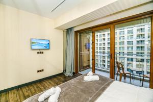 una habitación de hotel con una cama y una ventana grande en Park Azure One Bedroom Luxury Apartment, en Baku