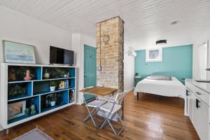 a bedroom with a bed and a table in a room at Whole House in Walker's Point in Milwaukee