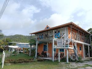 a house with a staircase in front of it at Posada In the Caribbean in Providencia