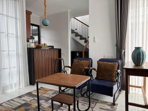 a living room with a table and chairs at Atmadeva Boutique Villas in Batu