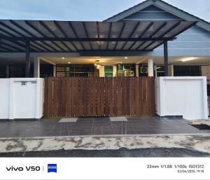 a wooden fence in front of a house at Laman Baraqah in Kuantan