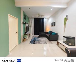 a living room with a couch and a tv at Laman Baraqah in Kuantan