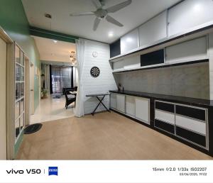 a kitchen with a ceiling fan and a dining room at Laman Baraqah in Kuantan