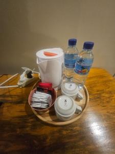 a tray with bottles of water and other items on a table at Rinjani Trekking Center in Senaru