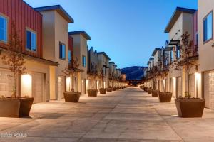 an empty street with potted plants and buildings at Modern Townhouse with HotTub & Garage in Park City +21 photos