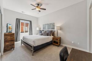 a bedroom with a bed and a ceiling fan at Modern Townhouse with HotTub & Garage in Park City