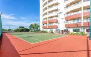 a tennis court in front of a building at Wyndhan Royal Hotel Resort Olimpia in Olímpia