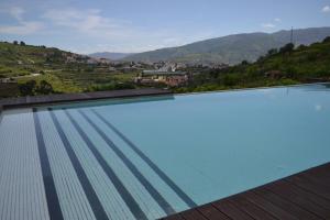 a swimming pool with a view of a mountain at Quinta do Santo no Douro - Casa T3 in Alcarias