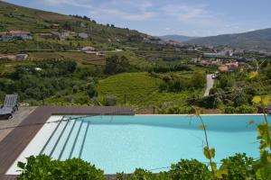 a swimming pool with a view of a mountain at Quinta do Santo no Douro - Casa T3 in Alcarias