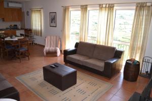 a living room with a couch and a table at Quinta do Santo no Douro - Casa T3 in Alcarias