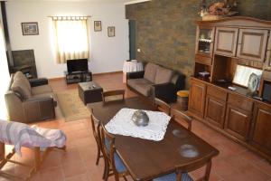 a living room with a couch and a table at Quinta do Santo no Douro - Casa T3 in Alcarias