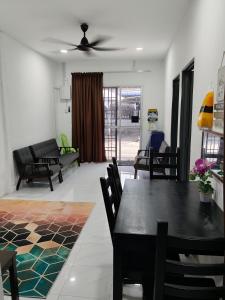 a dining room and living room with a table and chairs at Homestay Masjid Seberang Marang in Marang