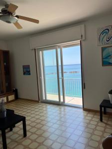 a living room with a view of the ocean at Casa sul mare in Vibo Valentia Marina +13 photos