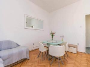 a bedroom with a table and chairs and a bed at Apartment Marjan - One Bedroom Apartment with shared Terrace in Posedarje
