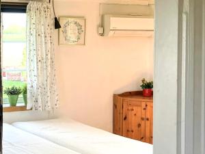 a bedroom with two beds and a window at 2 person holiday home in ÖDESHÖG in Ödeshög