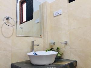 a bathroom with a sink and a mirror at Diyon'S Lodge in Ella +33 photos