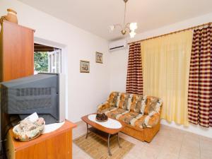 a living room with a couch and a tv at Apartments Aneli - Two Bedroom Apartment with Terrace and Sea View A2 in Sobra