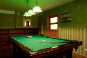 a billiard table in a room with green walls at Nowa - Ski SPA Hotel in Karpacz