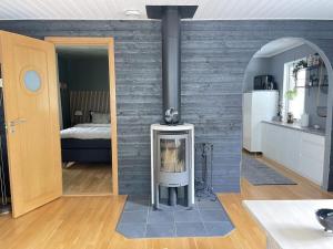 a fireplace in a living room with a brick wall at 4 star holiday home in LÖDDEKÖPINGE in Löddeköpinge