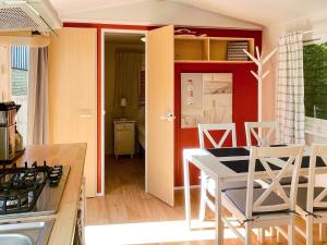a kitchen and dining room with a table and chairs at 4 person holiday home in Höllviken in Höllviken +22 photos