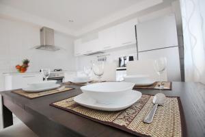 a kitchen with a table with white plates and wine glasses at Blue Wave Samui in Bophut 
