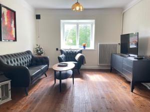 a living room with a couch and a table at 5 person holiday home in Stehag in Stehag