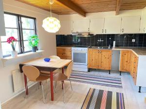 a kitchen with a table and chairs in a room at 4 person holiday home in ESLÖV in Eslöv