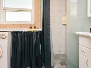 a bathroom with a shower with a black shower curtain at 6 person holiday home in Ansager in Ansager +28 photos
