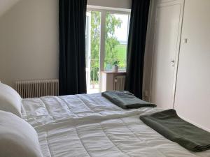 a bed with two green towels on top of it at 4 star holiday home in Förslöv in Förslöv