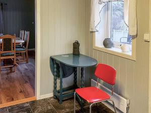 a table in a room with two chairs and a window at 8 person holiday home in hauglandshella 