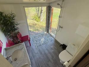 a small bathroom with a toilet and a window at 4 star holiday home in Grimstad in Grimstad