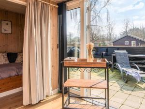 a dog sitting on a table in a room with a window at 6 person holiday home in Ansager in Ansager