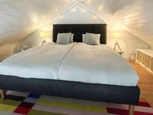 a bedroom with a large white bed in a attic at 7 person holiday home in Mönsterås in Mönsterås