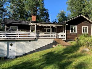 a home with a large porch and a house at 8 person holiday home in Ärla in Malmköping