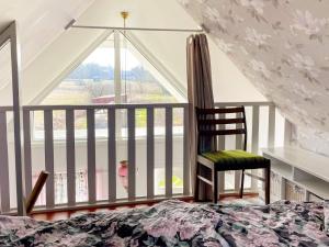 a bedroom with a bed and a large window at Charming Garden Cottage in Levide in Hemse