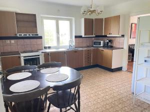 a kitchen with a table and some chairs and a table and a kitchen at 5 person holiday home in Stehag in Stehag