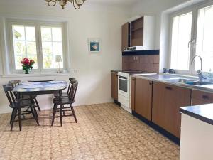 a kitchen with a table and chairs in a room at 5 person holiday home in Stehag in Stehag +19 photos