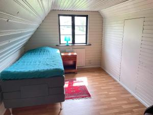 a small bedroom with a bed in a attic at 4 person holiday home in ESLÖV in Eslöv