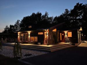 a small house with lights on in the night at 5 star holiday home in Skummeslövsstrand in Skummeslövsstrand