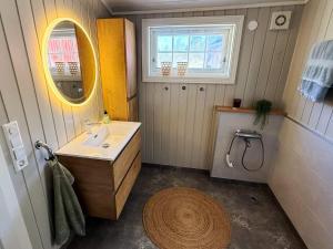 a small bathroom with a sink and a mirror at 4 star holiday home in Grimstad in Grimstad +47 photos
