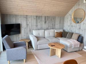 a living room with a couch and a table at 4 star holiday home in Huglo in Nordhuglo