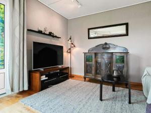 a living room with a television and a table at 8 person holiday home in Stavang in Stavang